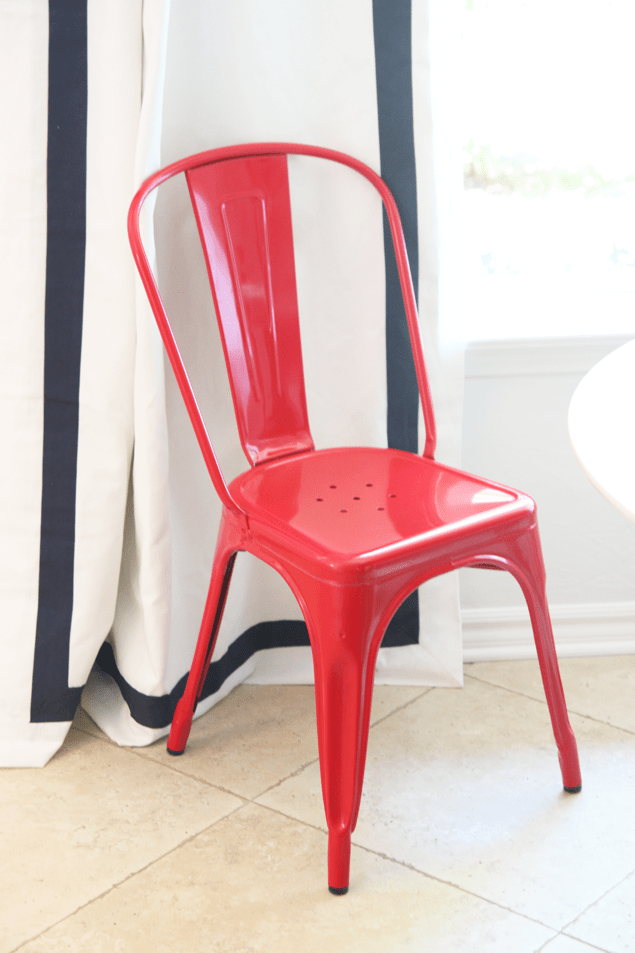 all white kitchen with saarinen table and tolix chairs